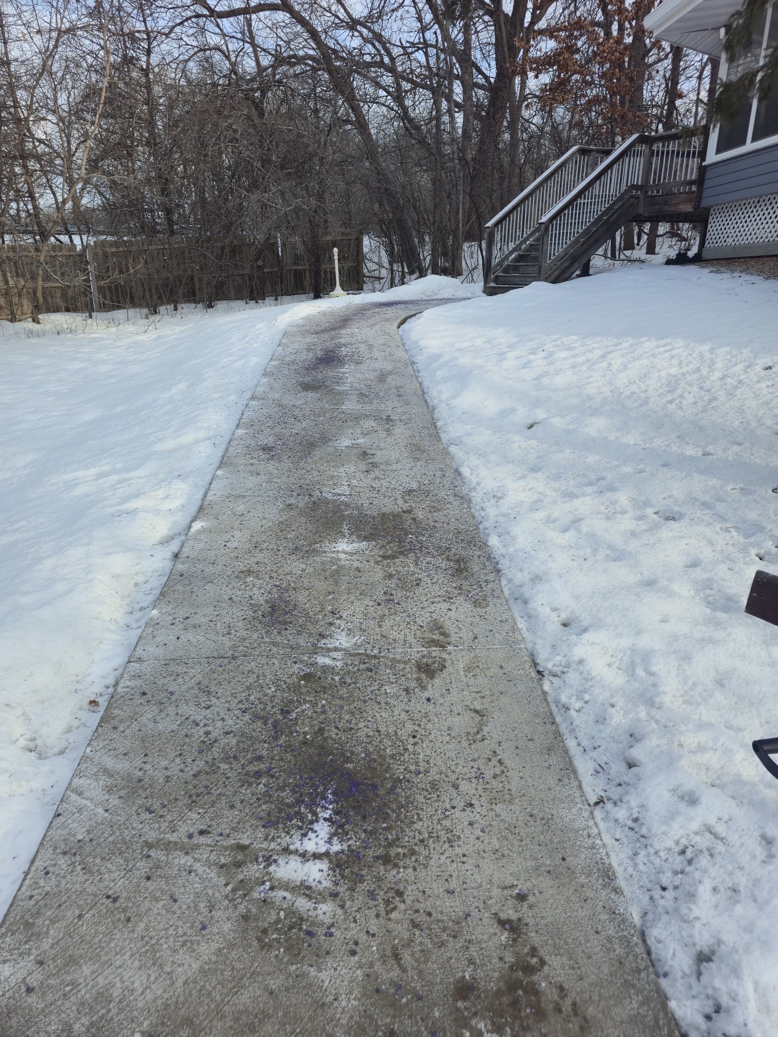 The same walkway cleared of snow with salt applied after snow removal